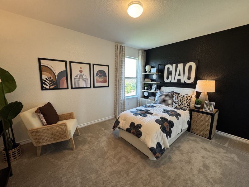 A chic bedroom featuring a bold black accent wall, floral bedding, and modern artwork, creating a cozy and stylish retreat. A chic bedroom featuring a bold black accent wall, floral bedding, and modern artwork, creating a cozy and stylish retreat.