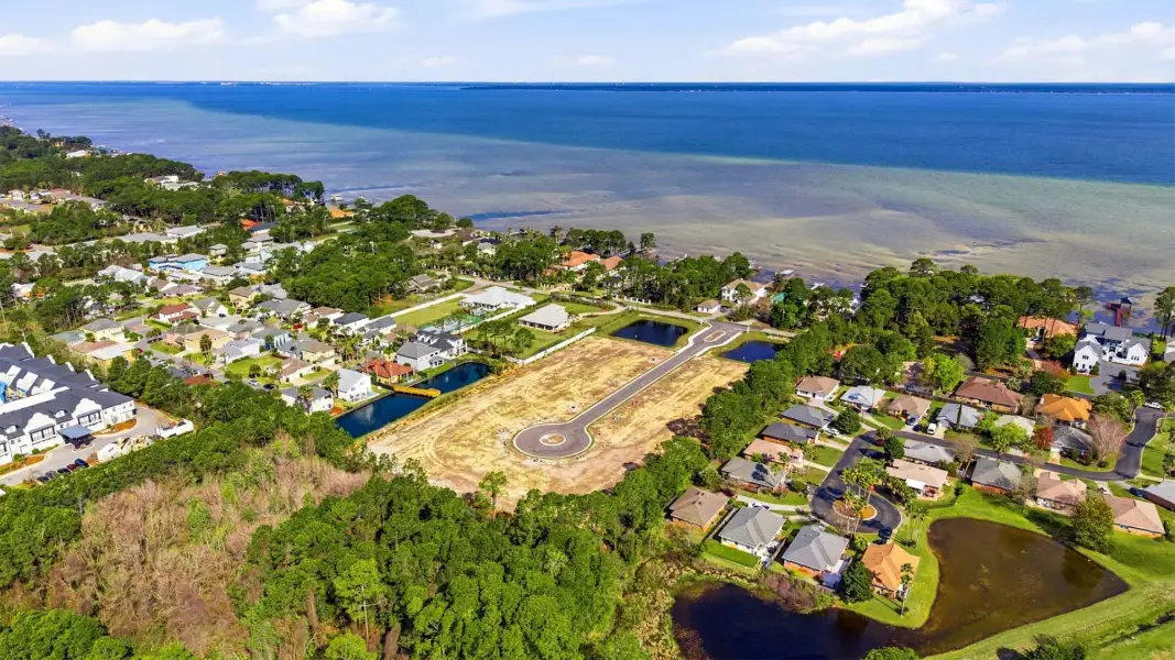 Aerial view of the Crest Bay Cottages community in Miramar Beach, FL, showing layout and nearby surroundings (Image 1). Aerial view of the Crest Bay Cottages community in Miramar Beach, FL, showing layout and nearby surroundings (Image 1).