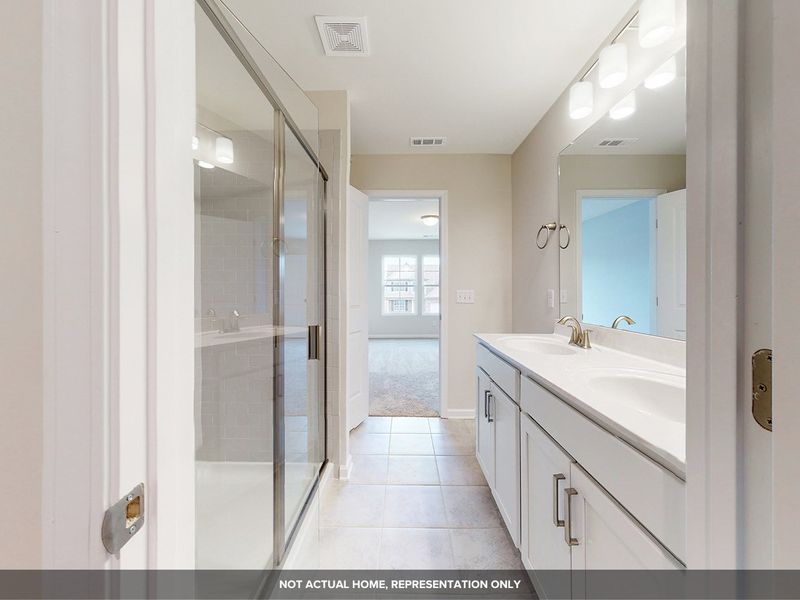 A bathroom with a glass shower. A bathroom with a glass shower.