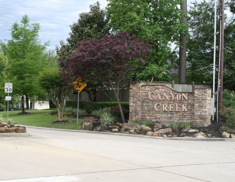 Entrance to the Canyon Creek community in Conroe, TX, featuring signage and landscaping (Image 9).