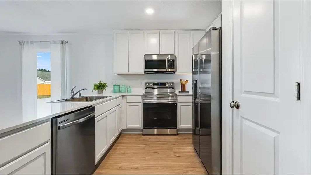 Furnished interior in a model home at Eagle's Ridge: Watermill in Pace (Image 8).