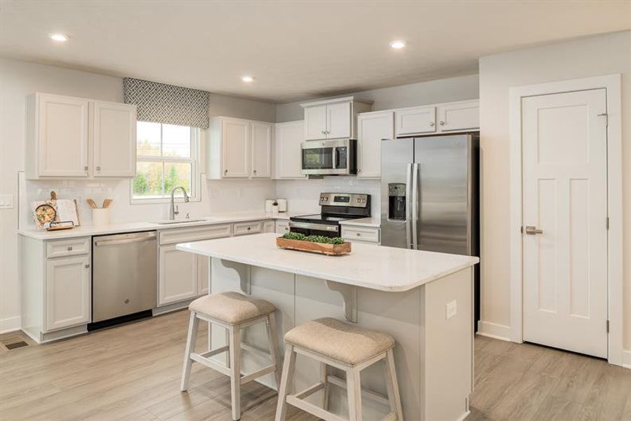 Light‑filled kitchens with stunning quartz countertops and an open, airy feel