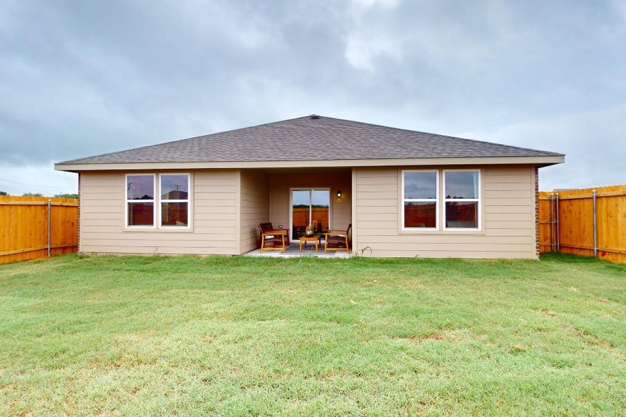 A house with a lawn in front of it. A house with a lawn in front of it.