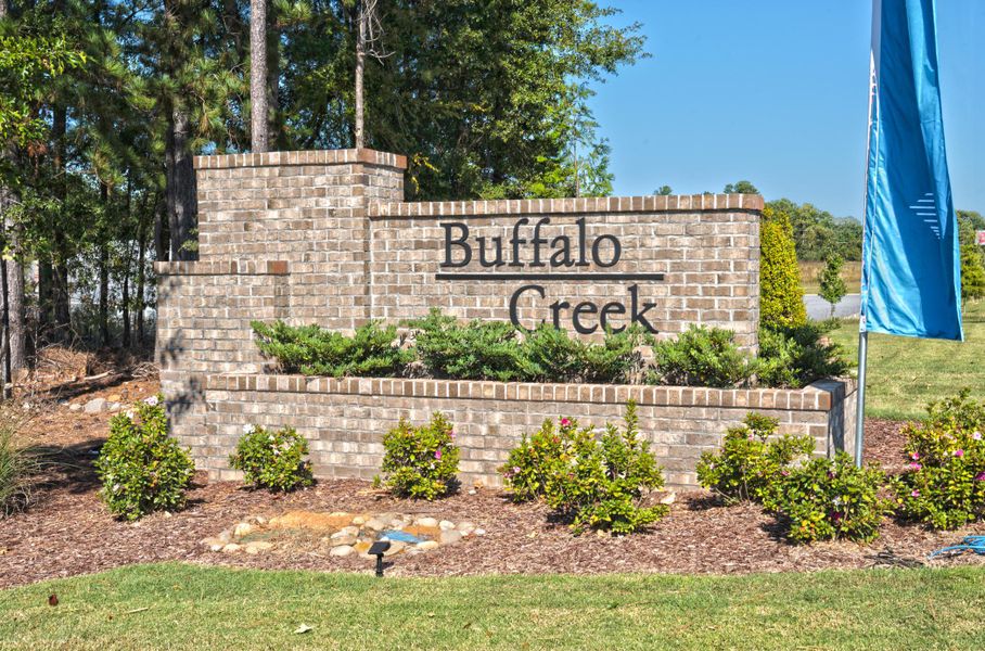 A sign on a brick wall. A sign on a brick wall.