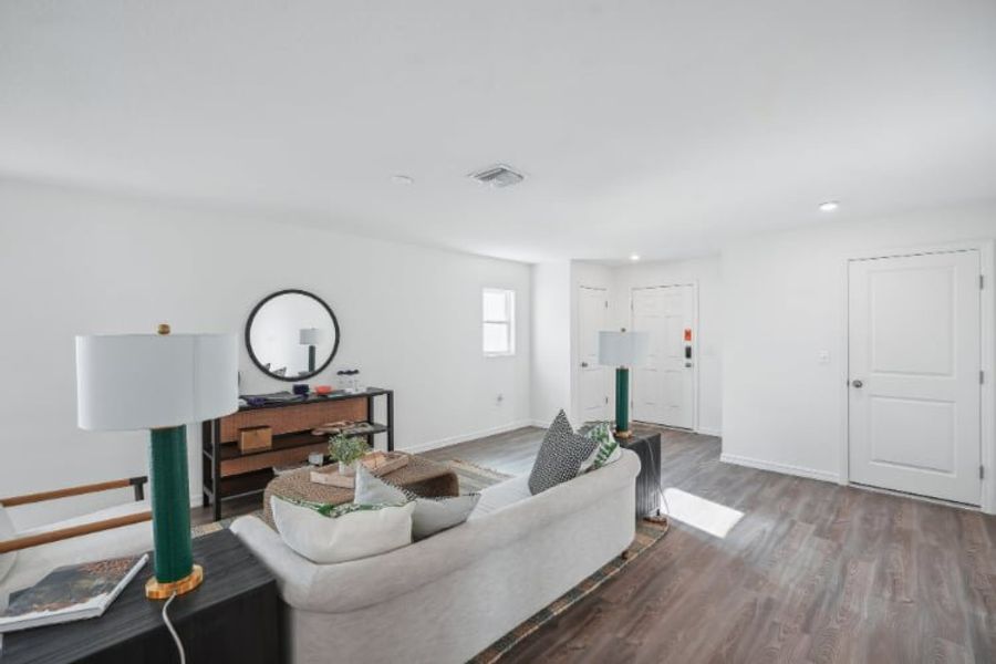 A living room with a couch and a mirror.