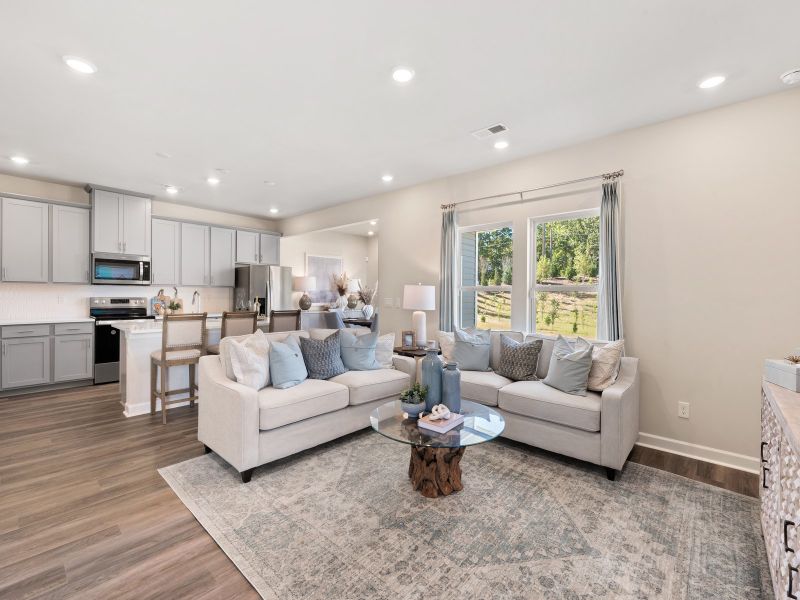 Large windows allow light to flood into the open-concept living space.