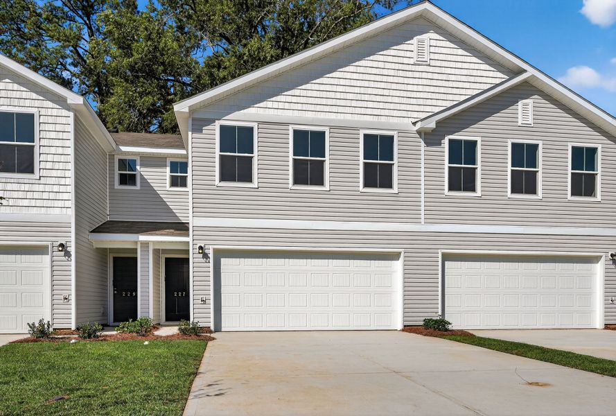 A white house with garages with Ronald Reagan Boyhood Home in the background.