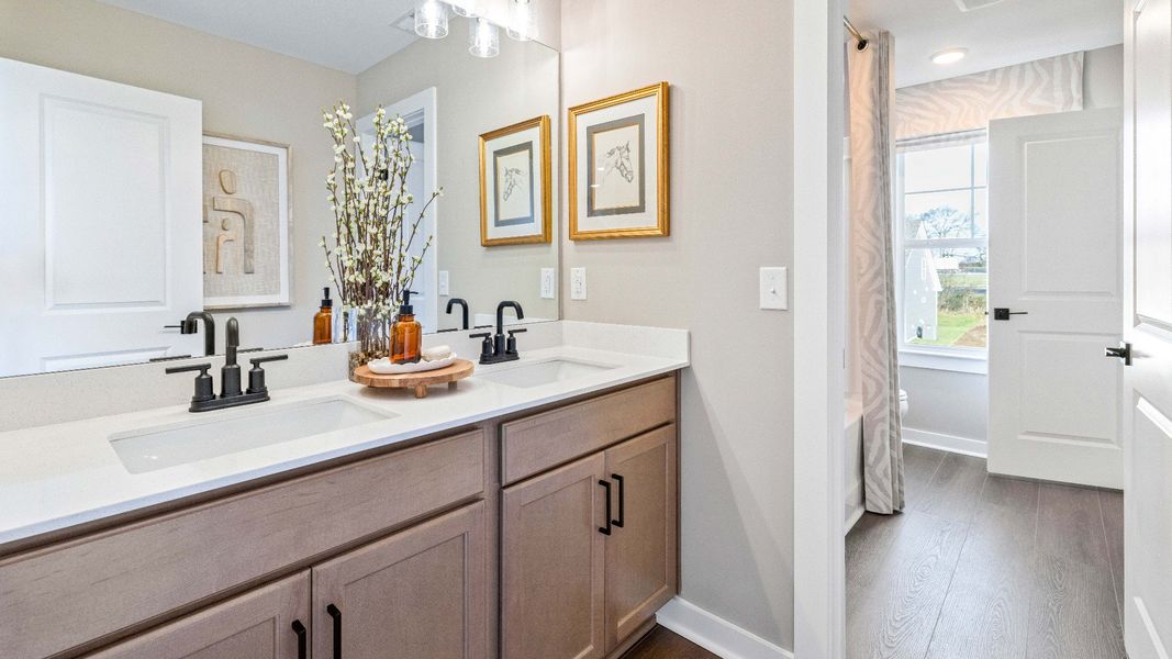 Double Vanity in the primary bathroom ensures there's always enough space on the quartz countertops