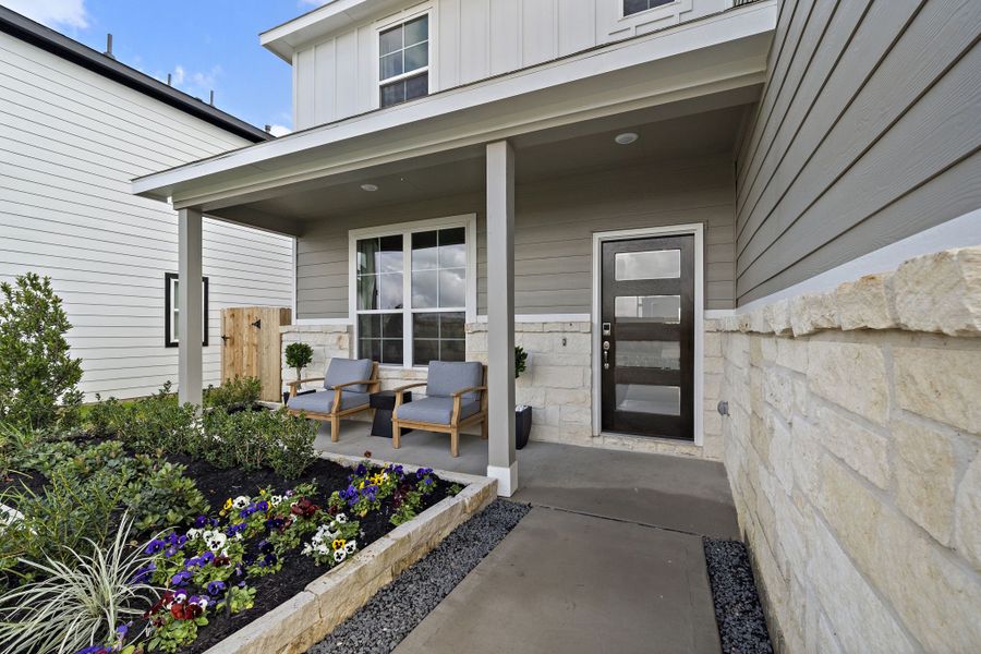 A patio with chairs and a table outside of a house. A patio with chairs and a table outside of a house.