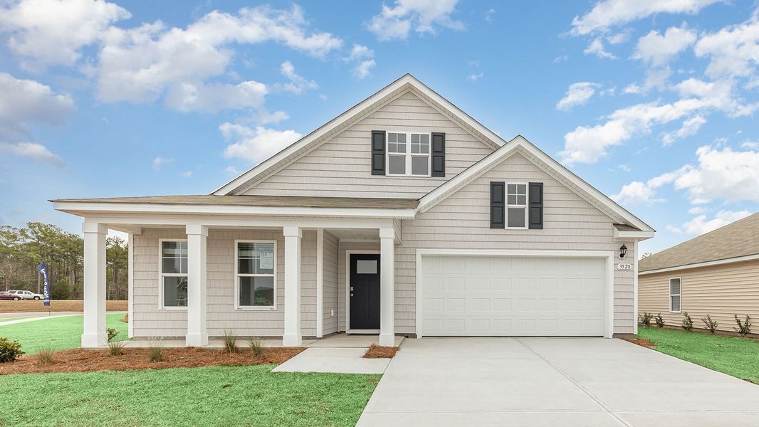 Front exterior of a home in the The Meadows at Wildwood Village community, located in Shallotte, NC (Image 13).