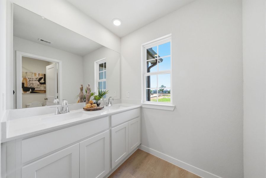A bathroom with white cabinets. A bathroom with white cabinets.