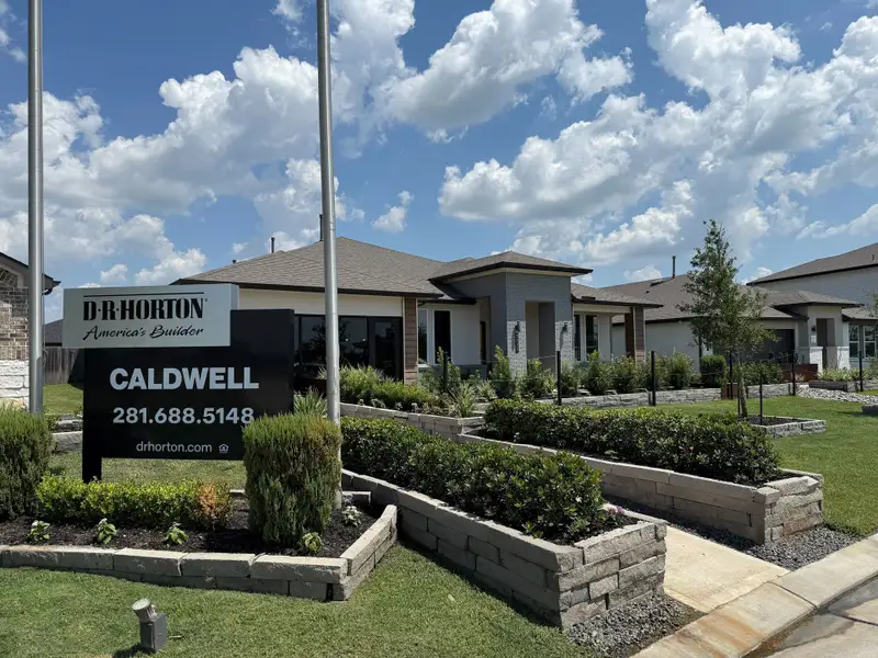 Modern home with sleek design and lush landscaping at Caldwell Ranch by D.R. Horton in Rosharon, TX.
