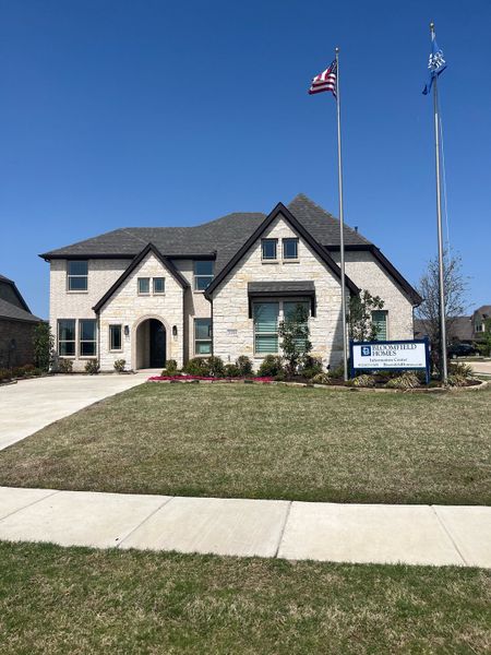 A beautiful stone-brick home with neat landscaping in Ridge Ranch Classic 60 by Bloomfield Homes, Mesquite, TX.