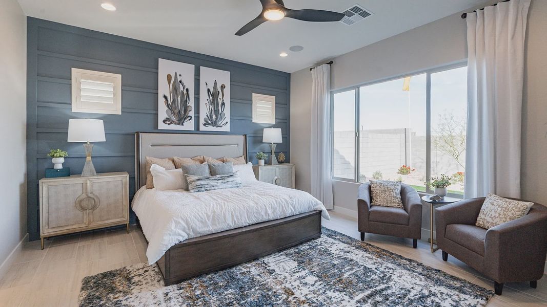 Luxurious bedroom featuring a bold accent wall, chic ceiling fan, and ample natural light in Arroyo Seco. Luxurious bedroom featuring a bold accent wall, chic ceiling fan, and ample natural light in Arroyo Seco.