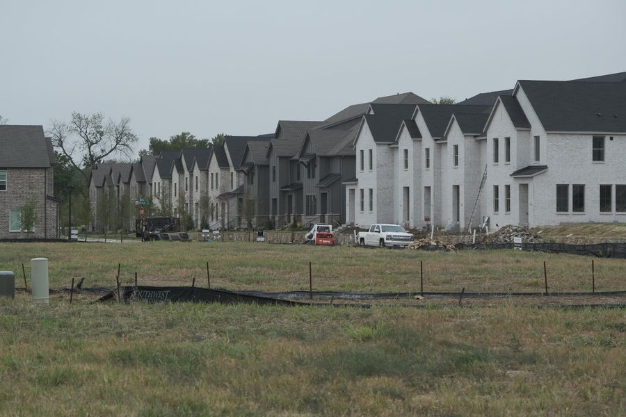 A modern row of homes with gabled roofs in Painted Tree - Village District by CB JENI Homes (McKinney, TX). A modern row of homes with gabled roofs in Painted Tree - Village District by CB JENI Homes (McKinney, TX).