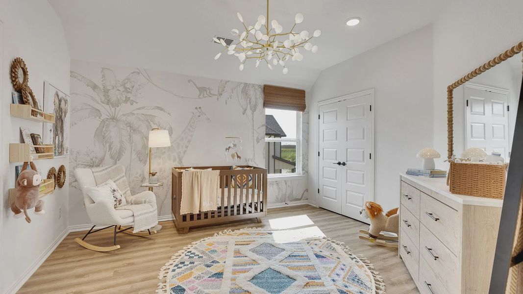 Luxurious nursery features a giraffe mural and modern chandelier, blending elegance with charm at Spring Creek.