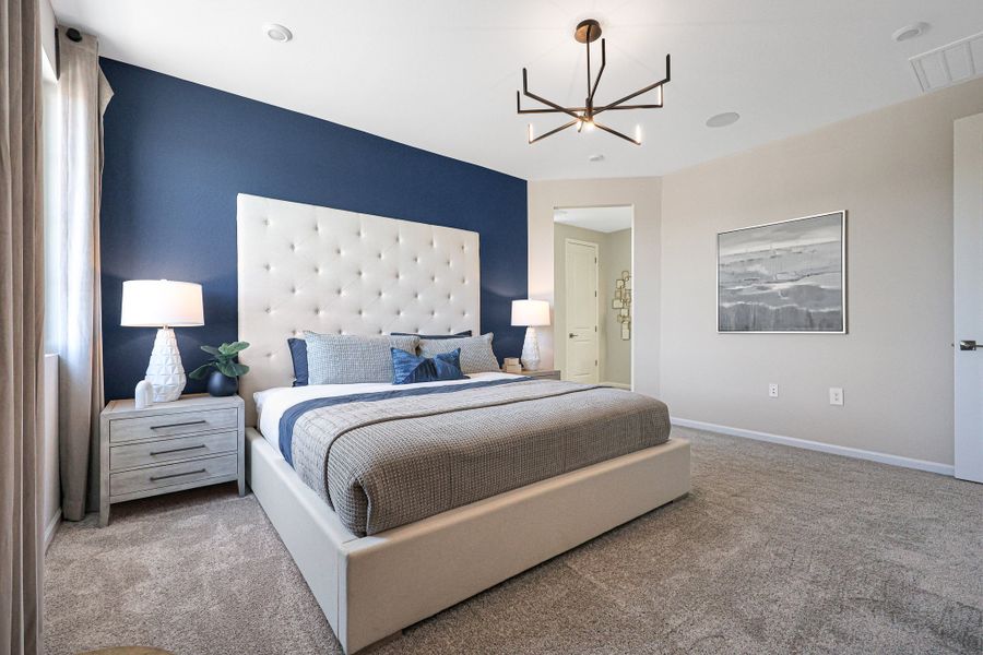 A bedroom with a bed and lamps. A bedroom with a bed and lamps.