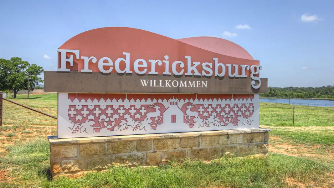 Entrance to the Trails of Windcrest community in Fredericksburg, TX, featuring signage and landscaping (Image 4).