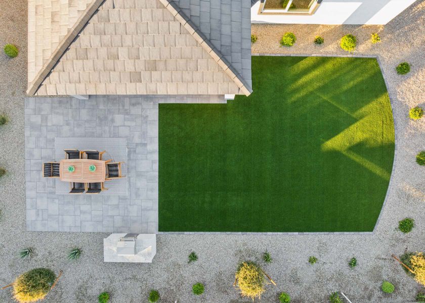 A brick building with a green lawn.