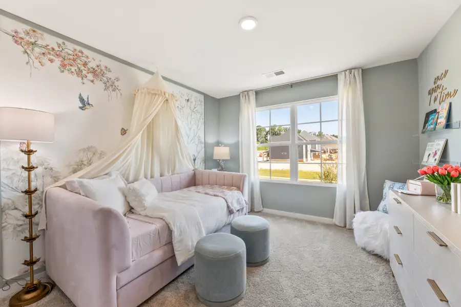 A bedroom with a bed and a couch.