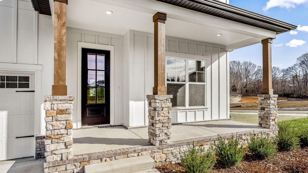 Luxurious front entryway into the home with black French door with brick accents Luxurious front entryway into the home with black French door with brick accents