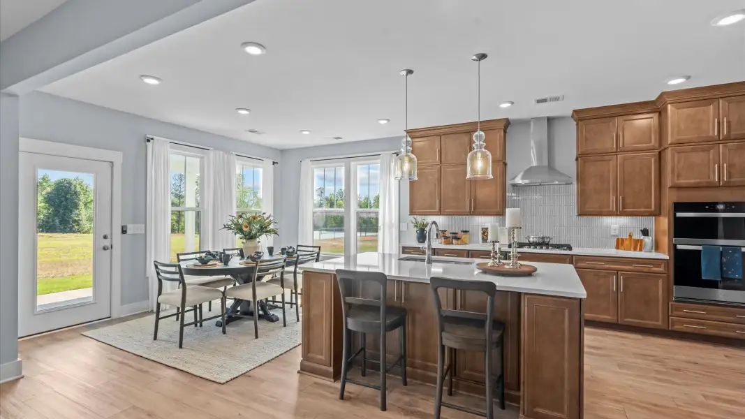 Tasteful kitchen with oversized island and stylish pendant lighting—crafted to high standards at Holliday Springs