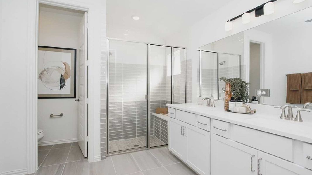 Luxurious bathroom in Cypress Green features sleek dual sinks and elegant glass shower enclosure. Luxurious bathroom in Cypress Green features sleek dual sinks and elegant glass shower enclosure.