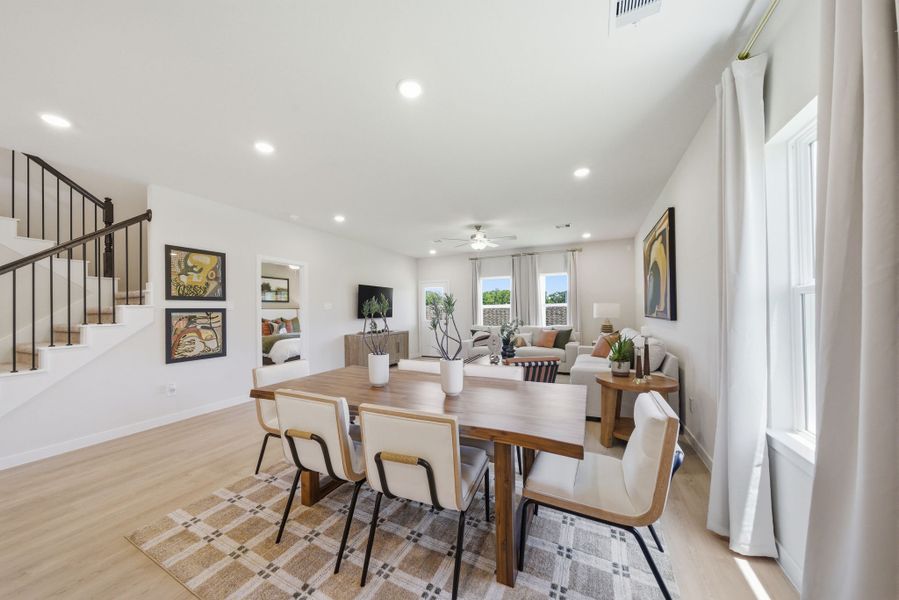 A dining room with a table and chairs. A dining room with a table and chairs.