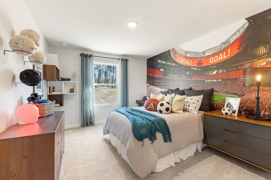 A bedroom with a bed and a desk. A bedroom with a bed and a desk.