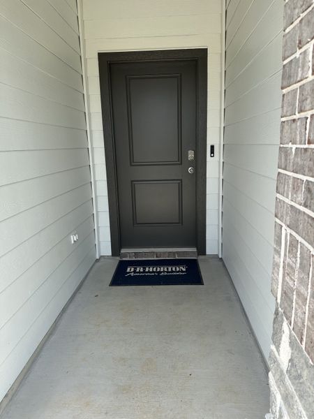 A welcoming entrance with a sleek dark door and a D.R. Horton mat, located in Silverthorne by D.R. Horton (Conroe, TX). A welcoming entrance with a sleek dark door and a D.R. Horton mat, located in Silverthorne by D.R. Horton (Conroe, TX).