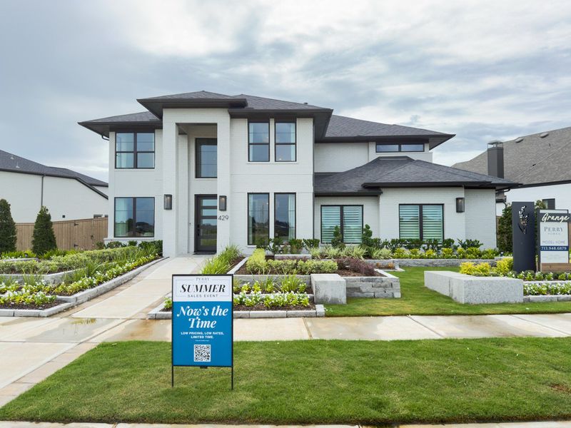 A modern white brick home with lush landscaping in Grange 60' by Perry Homes (Katy, TX). A modern white brick home with lush landscaping in Grange 60' by Perry Homes (Katy, TX).