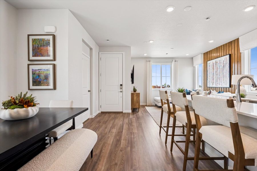 A dining room with a table and chairs.