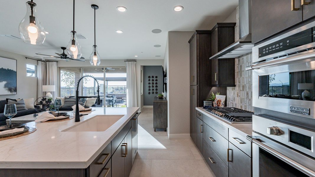 Experience elegance with marble countertops and sleek cabinetry in Mystic Villas' exquisite kitchen.