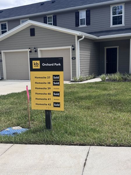 A contemporary gray townhome with black shutters in Orchard Park Townhomes by KB Home (St. Augustine, FL).