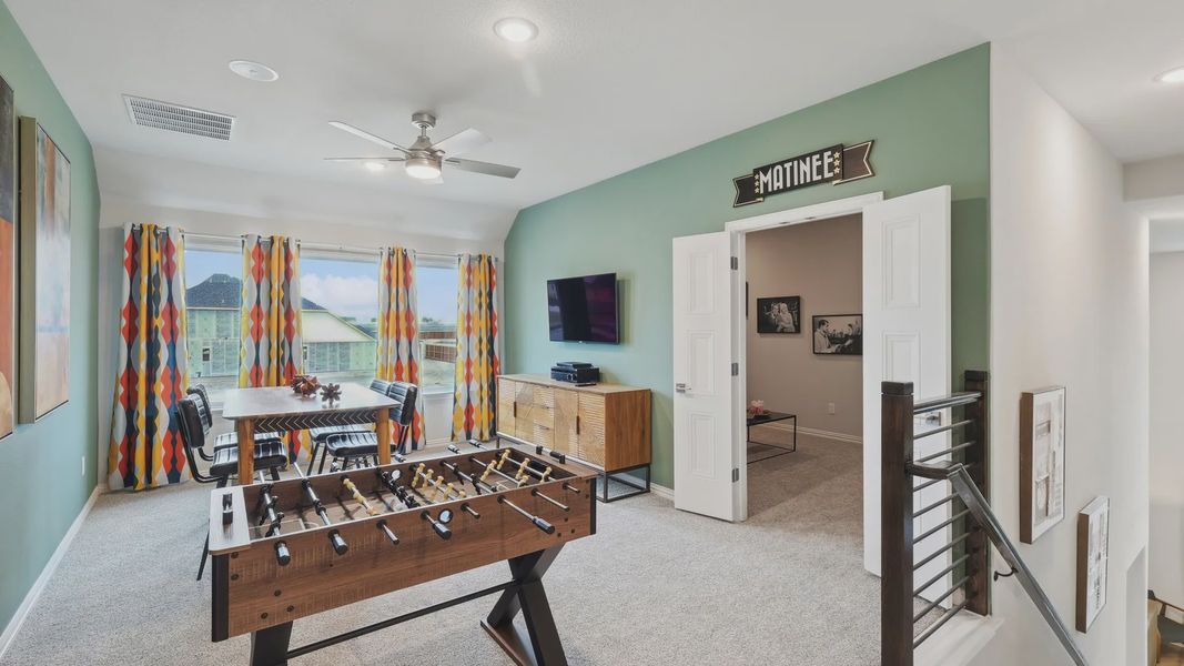 Elegant game room features sleek foosball, vibrant curtains, refined finishes. Wildflower Ranch. Elegant game room features sleek foosball, vibrant curtains, refined finishes. Wildflower Ranch.