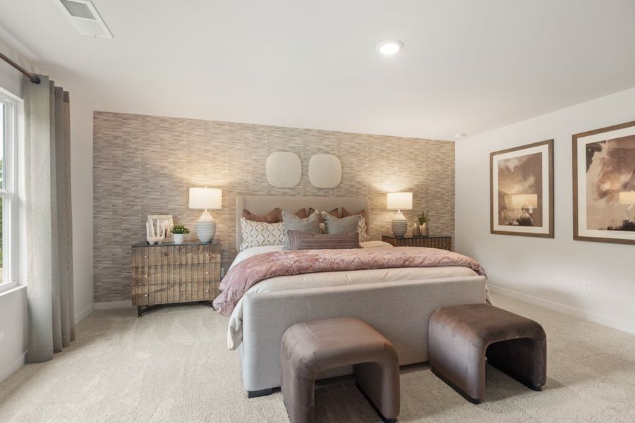 A bedroom with a bed and a couch. A bedroom with a bed and a couch.