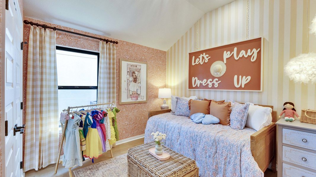 Vaulted ceiling and striped wallpaper elevate this children's bedroom in Lakeside Meadows. Vaulted ceiling and striped wallpaper elevate this children's bedroom in Lakeside Meadows.