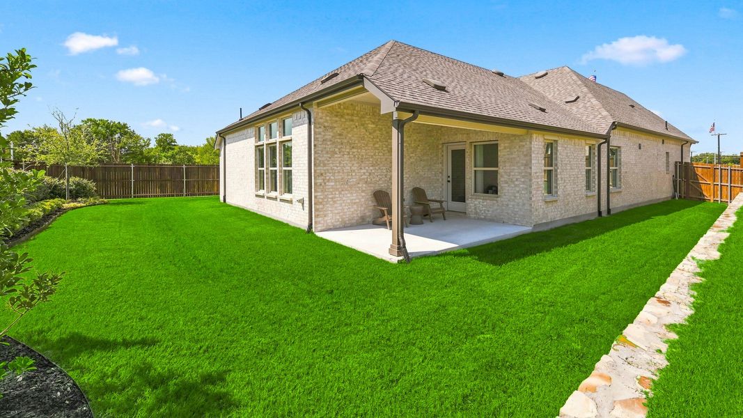 Elegant patio with brick facade and expansive lawn in Churchill. Modern fencing enhances privacy. Elegant patio with brick facade and expansive lawn in Churchill. Modern fencing enhances privacy.