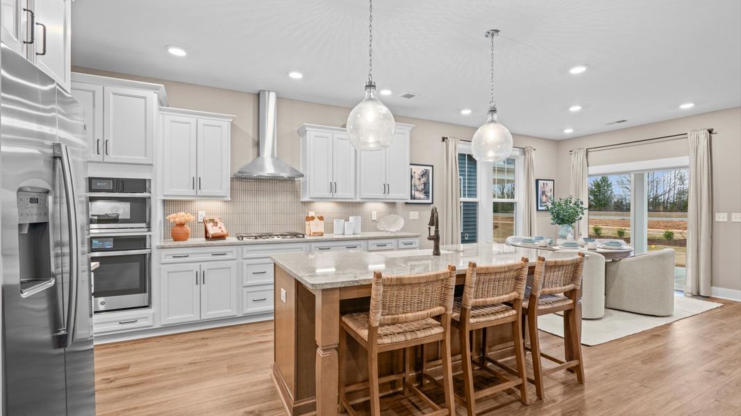 Elegant kitchen with large island and pendant lighting in this first-class DRB Homes design Elegant kitchen with large island and pendant lighting in this first-class DRB Homes design