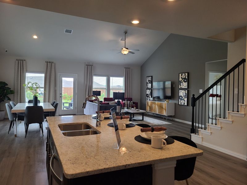 An open-concept living area with a sleek kitchen island, cozy seating, and contemporary decor. An open-concept living area with a sleek kitchen island, cozy seating, and contemporary decor.