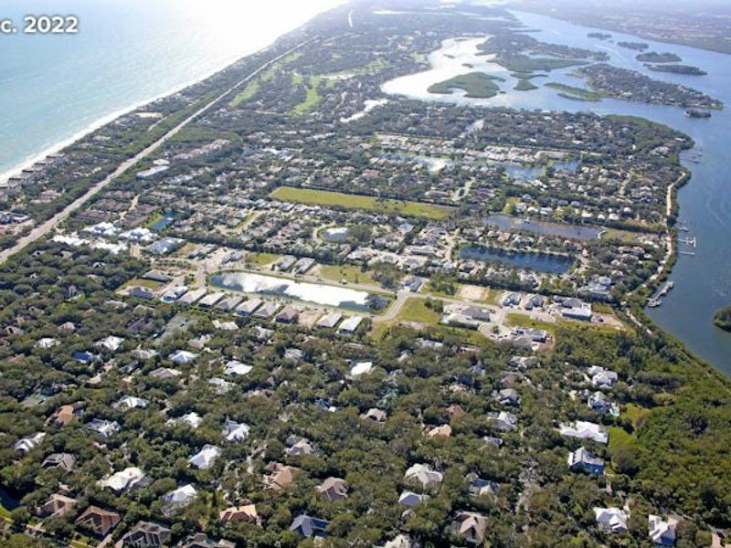 Aerial view of the The Strand community in Vero Beach, FL, showing layout and nearby surroundings (Image 25).