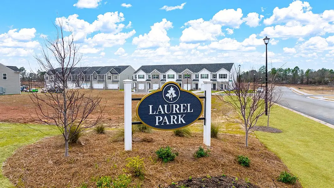 Entrance to the Laurel Park Townhomes community in Hephzibah, GA, featuring signage and landscaping (Image 1).