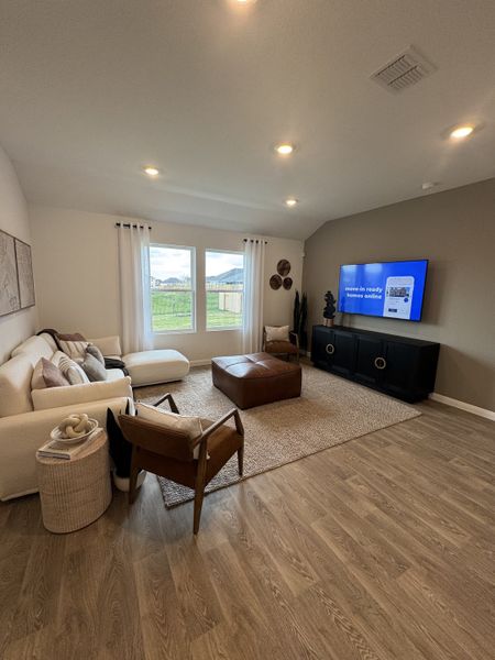 A cozy living room featuring a comfortable sofa, sleek armchair, and large window with natural light. A cozy living room featuring a comfortable sofa, sleek armchair, and large window with natural light.