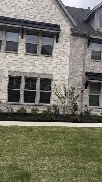 Elegant stone facade home with manicured landscaping in Plano Gateway by Beazer Homes (Plano, TX).