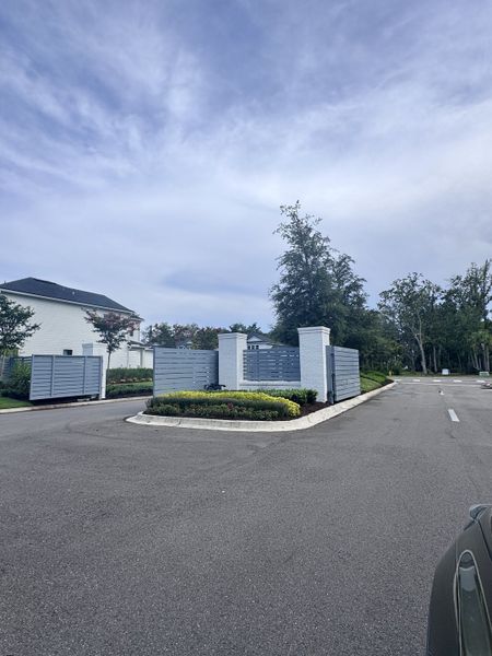 A modern gated entrance with lush landscaping in RiverTown - Meadows by Mattamy Homes (St. Johns, FL).