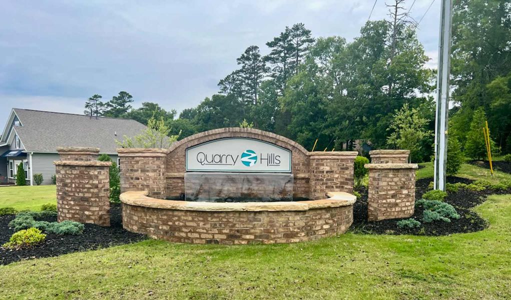 Entrance to the Quarry Hills - D.R. Horton community in Graham, NC, featuring signage and landscaping (Image 1). Entrance to the Quarry Hills - D.R. Horton community in Graham, NC, featuring signage and landscaping (Image 1).