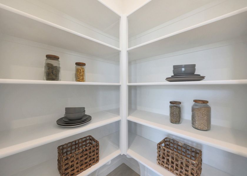A white shelving unit with baskets and baskets.