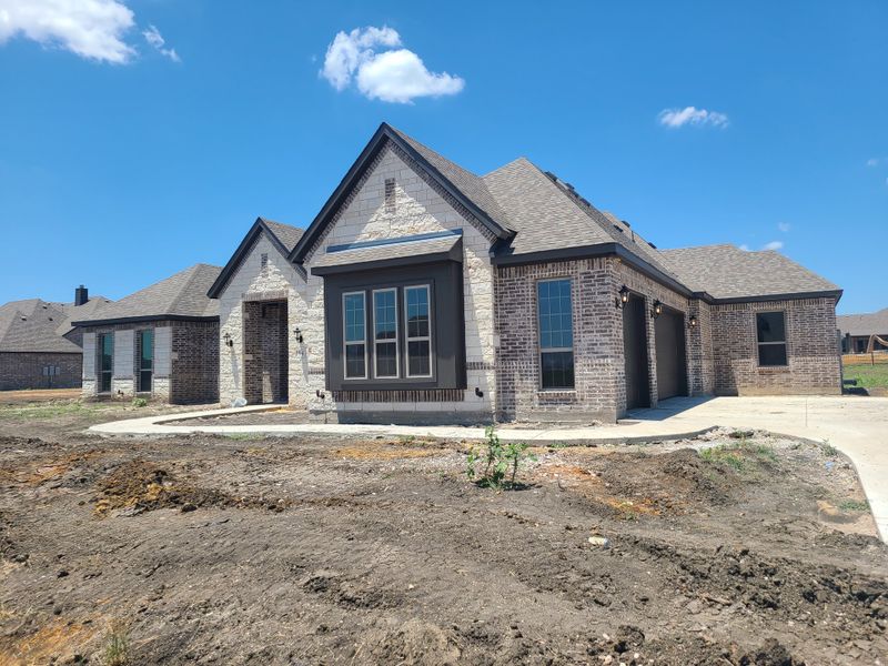 A charming brick and stone home with a landscaped path in Sterling Meadows by Stonehollow Homes (Howe, TX). A charming brick and stone home with a landscaped path in Sterling Meadows by Stonehollow Homes (Howe, TX).