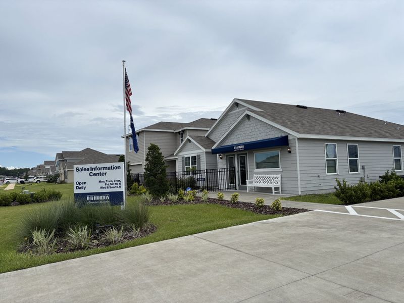 A welcoming sales center with landscaped surroundings in Avalon Woods by D.R. Horton (Newberry, FL).