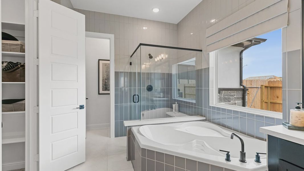 Beamer Villas bathroom boasts a chic soaking tub, seamless glass shower, and elegant tilework. Beamer Villas bathroom boasts a chic soaking tub, seamless glass shower, and elegant tilework.